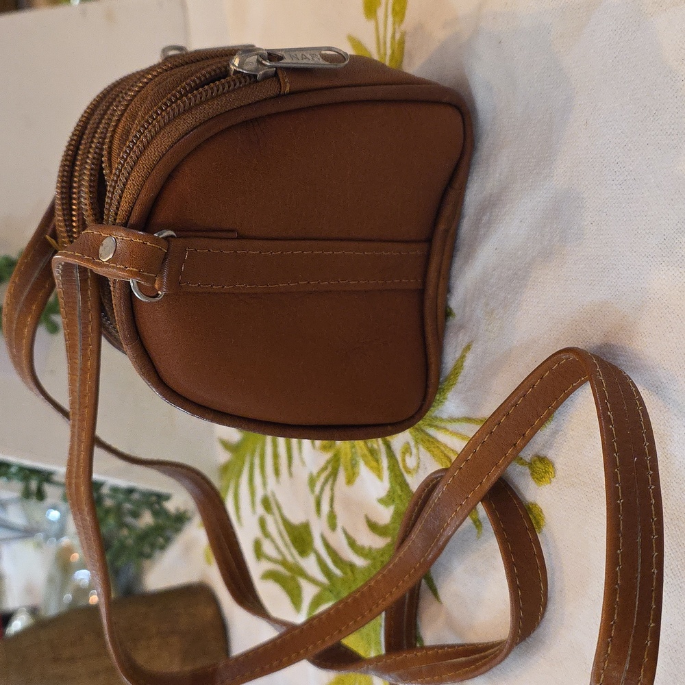 Expandable leather crossbody mini purse. Zips closed - then opens.6" L